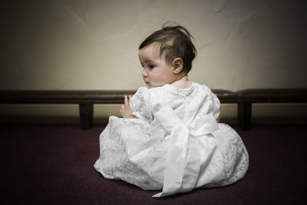 Color portrait of toddler girl during her baptsim photographed by ArtShaped Photography and Birth Services.