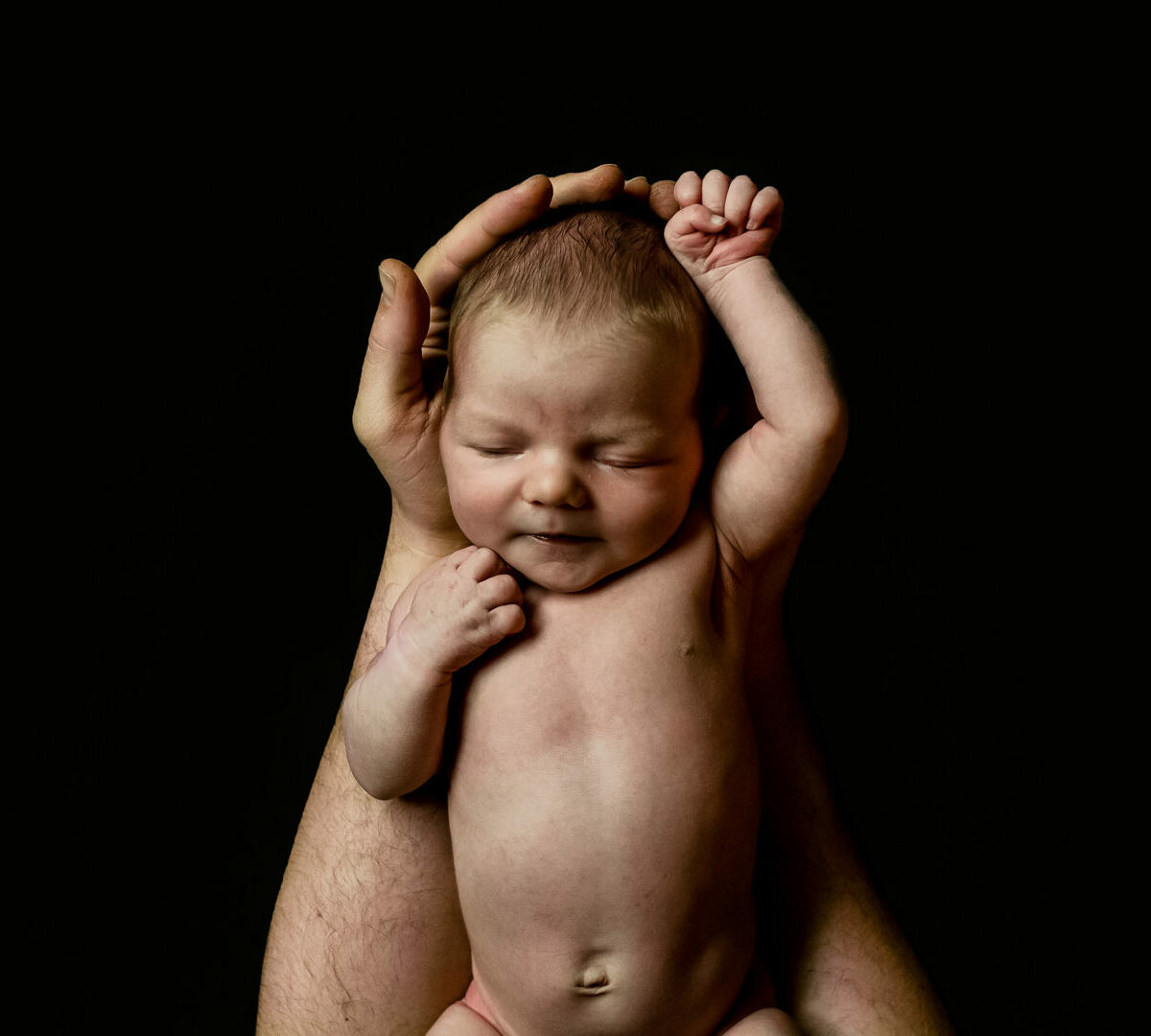 color image of newborn on black contrast photographed by pregnancy and newborn Los Angeles photographer Diana Hinek for Dear Birth