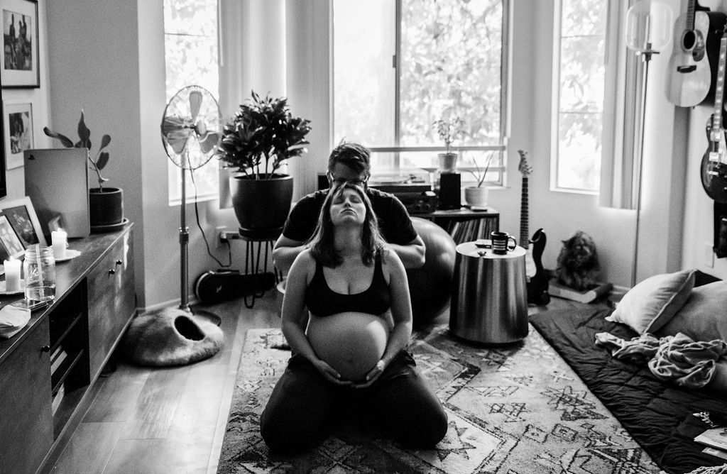 Black and white image of a homebirth during the full moon with Los Angeles birth photographer dearbirth