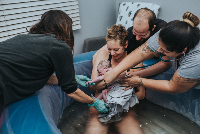 Color image of home water birth photographed by Los Angeles birth photographer and videographer Diana Hinek for Dear Birth