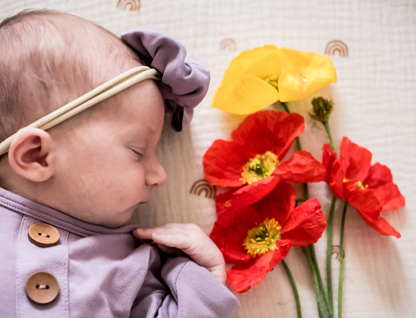 Close up of newborn and poppies during a babies and flower photo session in Culver city with Newborn and maternity photographer and videographer Diana Hinek for Dear Birth