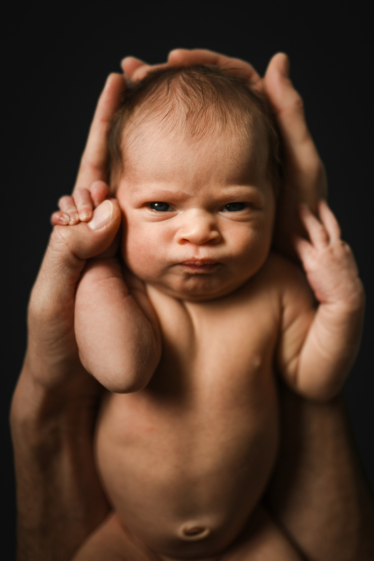 Color image of newborn baby holding onto her dad's hand while photographed by Los Angeles Pregnancy & Newborn Birth Photographer and videographer Diana Hinek for Dear Birth