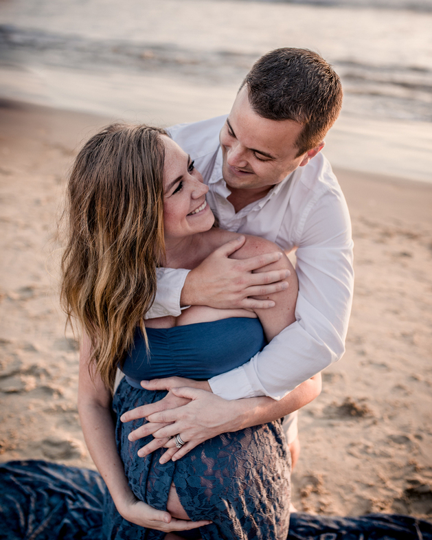 Color image of father to be hugging his pregnant wife during a materning shoot in Santa Monica with Los Angeles Pregnancy and Family photographer Diana Hinek for Dear Birth