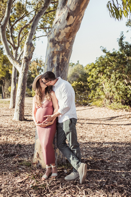 Baby makes 4: kissing under a tree. Maternity photoshoot with Los Angeles family photographer and videographer Diana Hinek for Dear Birth