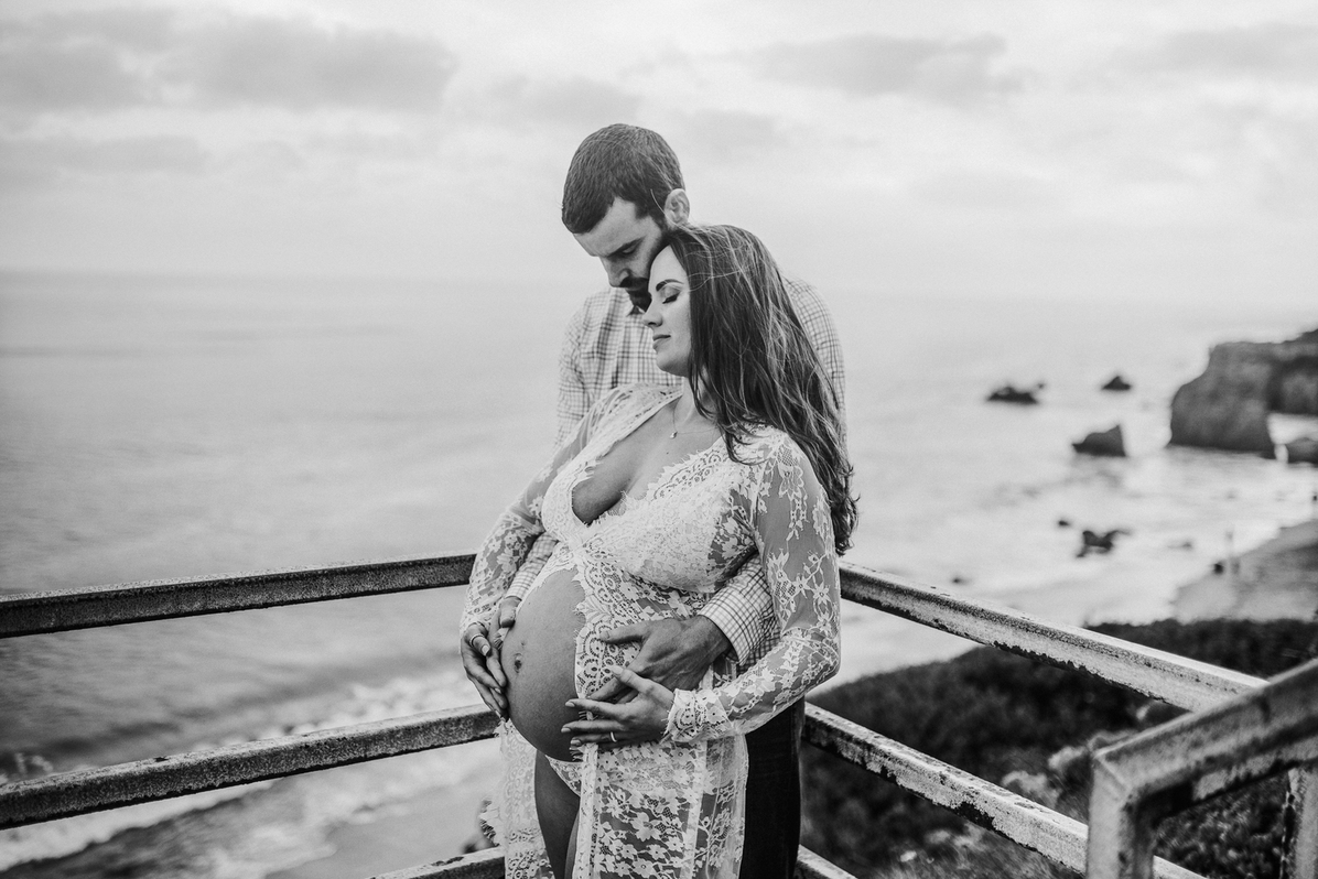 black and white image of pregnant couple photographed at the look out point of el Matador by Los Angeles Pregnancy & Newborn Birth Photographer Diana Hinek for Dear Birth