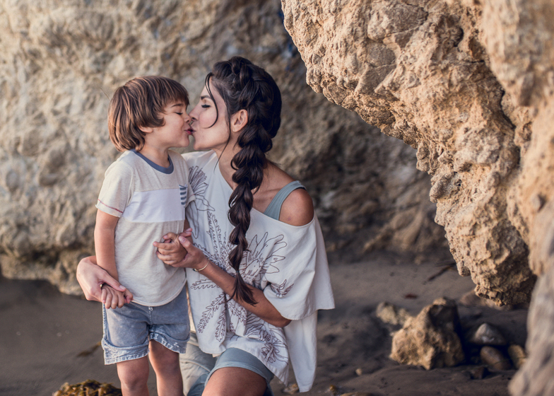 Mother and son kiss at El Matador beach as portrayed by Los Angeles Santa Monica family Photographer Diana Hinek