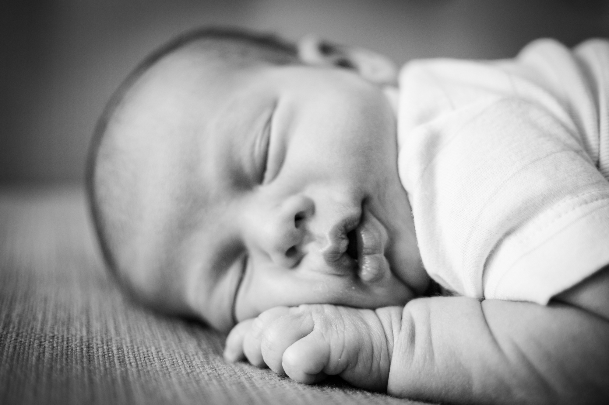 Black and white image of newborn baby as photographed by Santa Monica newborn and pregnancy photographer Diana Hinek for Dear Birth