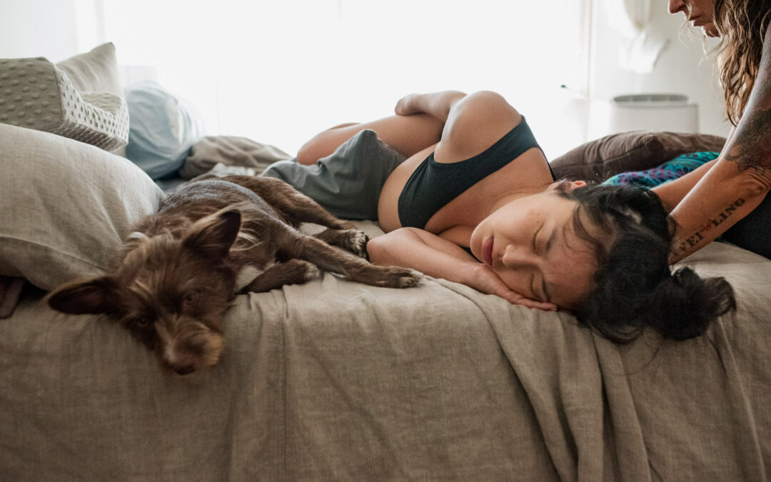 Color image of dog as emotional support, aka Guardian of the Journey, to mother in labor as captured by Los Angeles Birth photographer Diana Hinek for Dear Birth